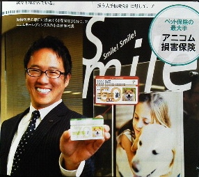 動物病院の窓口に提示する「保険証」を持つ、<br />アニコムホールディングスの小森伸昭社長