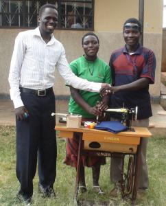 Ojok Michael recieves his amchine with his wife
